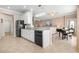 Kitchen with granite counters, white cabinets, and breakfast bar at 2558 Hobblebrush Dr, North Port, FL 34289