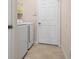 Laundry room with washer, dryer, and built-in shelving at 2558 Hobblebrush Dr, North Port, FL 34289