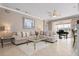 Living room with a grand piano, sectional sofa, and access to backyard at 2558 Hobblebrush Dr, North Port, FL 34289