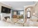 Bright living room features a fireplace, large TV, and ample seating at 2558 Hobblebrush Dr, North Port, FL 34289