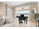 Living area with a grand piano and access to a patio at 2558 Hobblebrush Dr, North Port, FL 34289