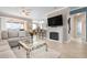 Spacious living room with a fireplace, sectional sofa, and large TV at 2558 Hobblebrush Dr, North Port, FL 34289