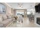 Open floor plan living room with sectional sofa, fireplace, and breakfast bar at 2558 Hobblebrush Dr, North Port, FL 34289