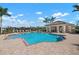 Community pool with lounge chairs and covered seating area at 2558 Hobblebrush Dr, North Port, FL 34289