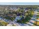Aerial view of single-story home with pool, lush landscaping, and quiet neighborhood at 2899 Ensenada Ln, North Port, FL 34286