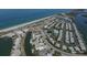 Aerial view of a coastal community with beach, waterway, and homes at 2899 Ensenada Ln, North Port, FL 34286