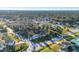 Bird's-eye view of a residential area with mature trees at 2899 Ensenada Ln, North Port, FL 34286