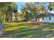 Spacious backyard with lush lawn and tropical landscaping at 2899 Ensenada Ln, North Port, FL 34286