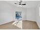 Bedroom with wood-look floors, ceiling fan, and sliding doors to the pool at 2899 Ensenada Ln, North Port, FL 34286