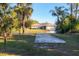 Single story home with a large yard and palm trees at 2899 Ensenada Ln, North Port, FL 34286