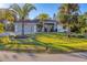 Single-story home with attached garage and lush landscaping at 2899 Ensenada Ln, North Port, FL 34286