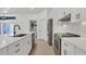 Modern kitchen features white cabinets, stainless steel appliances, and quartz countertops at 2899 Ensenada Ln, North Port, FL 34286
