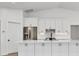 Modern kitchen with white cabinets, island, and stainless steel appliances at 2899 Ensenada Ln, North Port, FL 34286