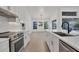 Bright kitchen boasts an island, stainless steel appliances, and a view to the dining area at 2899 Ensenada Ln, North Port, FL 34286