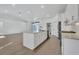 Modern kitchen with white cabinets, island, and stainless steel appliances at 2899 Ensenada Ln, North Port, FL 34286