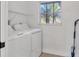 Laundry room with washer, dryer, and overhead shelving at 2899 Ensenada Ln, North Port, FL 34286