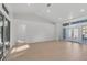 Spacious living area with light wood floors and French doors at 2899 Ensenada Ln, North Port, FL 34286