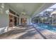 Covered patio overlooking a refreshing pool and access to kitchen at 2899 Ensenada Ln, North Port, FL 34286