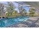 Inviting screened pool with paver deck and lush landscaping at 2899 Ensenada Ln, North Port, FL 34286