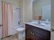 Simple bathroom with shower/tub combo and dark vanity at 295 Cassano Drive, Nokomis, FL 34275