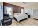 Spacious Primary bedroom with large bed, two chairs, and plenty of natural light at 295 Cassano Drive, Nokomis, FL 34275