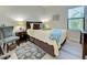 Cozy bedroom with a full-size bed and a teal accent chair at 295 Cassano Drive, Nokomis, FL 34275