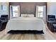 Bright bedroom with a king-size bed and two relaxing armchairs at 295 Cassano Drive, Nokomis, FL 34275