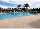 Inviting community pool with lounge chairs and umbrellas at 295 Cassano Drive, Nokomis, FL 34275