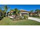 Single-story house with palm trees and well-manicured lawn at 295 Cassano Drive, Nokomis, FL 34275