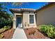 Front entrance of a home with a blue door and walkway at 295 Cassano Drive, Nokomis, FL 34275