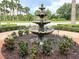 Ornate fountain with landscaping and lighting in a courtyard setting at 295 Cassano Drive, Nokomis, FL 34275