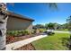 Landscaped walkway leading to a home with mature tropical plants at 295 Cassano Drive, Nokomis, FL 34275