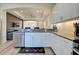 Open kitchen with white cabinets and granite countertops at 295 Cassano Drive, Nokomis, FL 34275
