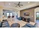 Living area with blue couches, ottoman, and view of kitchen at 295 Cassano Drive, Nokomis, FL 34275