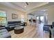 Open-concept living room and kitchen with hardwood floors at 295 Cassano Drive, Nokomis, FL 34275