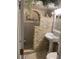 Bathroom with stone wall accents, pedestal sink, and a shower with a decorative niche at 3421 Normandy Dr, Port Charlotte, FL 33952