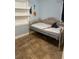 Small bedroom with a daybed, built-in shelves, and tile flooring at 3421 Normandy Dr, Port Charlotte, FL 33952