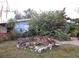 Light blue house with stone accents and lush landscaping, partially visible red fence at 3421 Normandy Dr, Port Charlotte, FL 33952