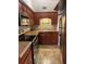 Galley kitchen with wood cabinets, stainless steel appliances, and tile flooring at 3421 Normandy Dr, Port Charlotte, FL 33952