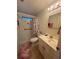 A well lit bathroom contains a toilet, shower, sink and vanity with modern fixtures at 356 Longwood Dr, Venice, FL 34285