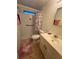 A well lit bathroom contains a toilet, shower, sink and vanity with modern fixtures at 356 Longwood Dr, Venice, FL 34285