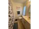 This bathroom features a toilet, vanity, sink, a shower curtain, and a window at 356 Longwood Dr, Venice, FL 34285