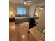 This bedroom is furnished with a daybed, desk, and a mirrored closet at 356 Longwood Dr, Venice, FL 34285
