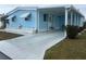 Charming blue single-story home featuring awnings, a covered entrance, and a well-maintained yard at 356 Longwood Dr, Venice, FL 34285