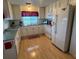 Bright kitchen with white cabinets, laminate floors, and stainless steel appliances at 356 Longwood Dr, Venice, FL 34285