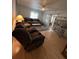 Bright living room has wood floors, a ceiling fan, and a sliding glass door to a sunroom at 356 Longwood Dr, Venice, FL 34285