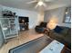 A cozy living room with wood floors features a TV, fireplace, recliner, and comfortable sofa at 356 Longwood Dr, Venice, FL 34285