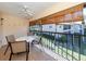 Private screened balcony with outdoor seating and canal view at 380 Three Lakes Ln # F, Venice, FL 34285