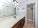 Clean bathroom with a large vanity and tiled shower at 380 Three Lakes Ln # F, Venice, FL 34285
