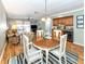 Dining room with wood table and chairs, view of living room at 380 Three Lakes Ln # F, Venice, FL 34285